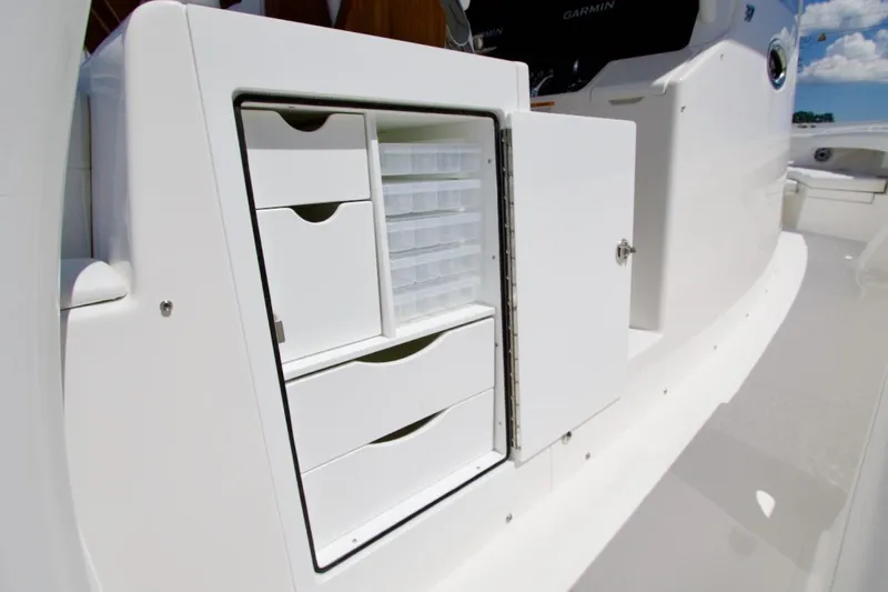 Slide: The Image of Storage compartment on 2026 Regulator 37 boat, featuring organized drawers and shelves. - 8