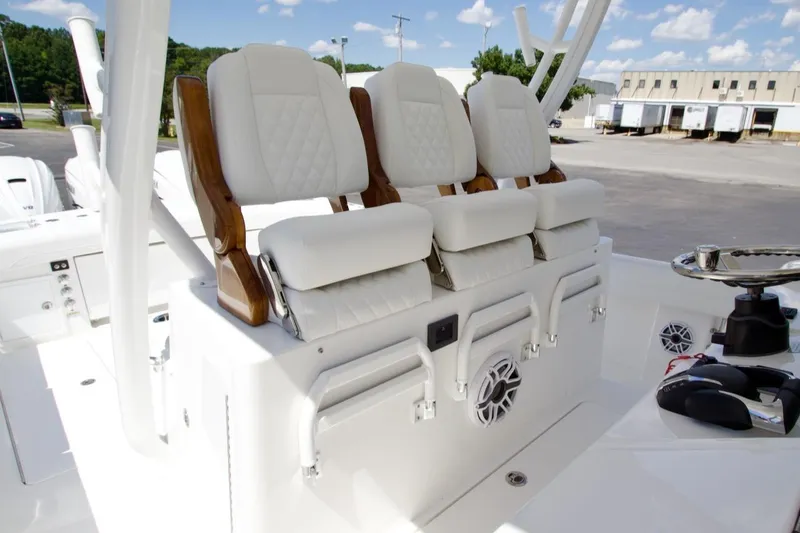Slide: The Image of Luxury seating on 2026 Regulator 37 boat, featuring white cushioned chairs and sleek design. - 9