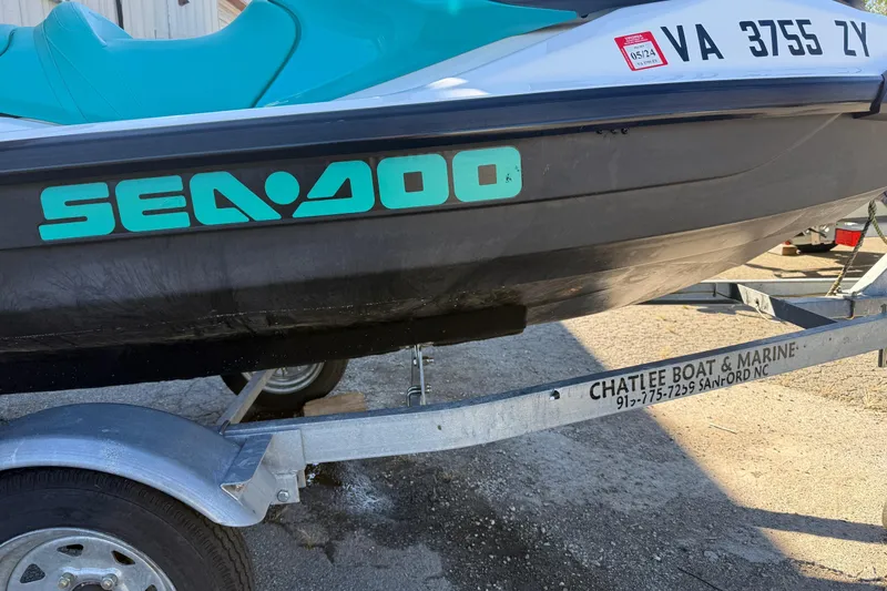 Slide: The Image of 2021 Seadoo GTI90 jet ski on trailer, featuring teal seat and branding. - 24