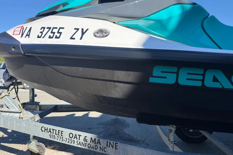 Slide: The Image of 2021 Seadoo GTI90 jet ski on trailer, featuring teal and black design. - 27