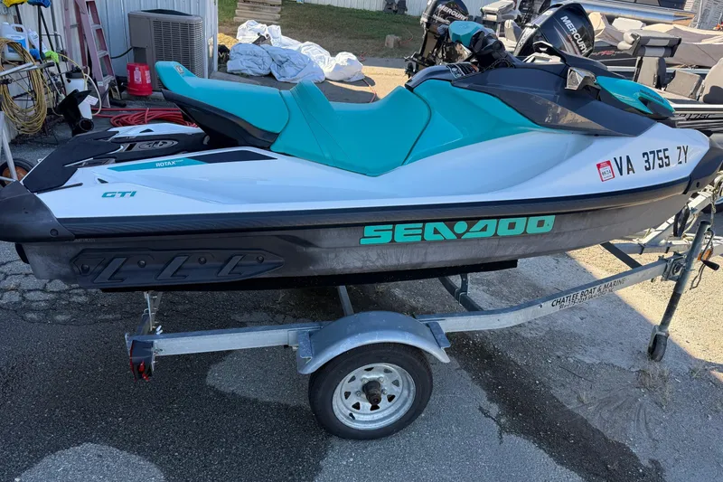 Slide: The Image of 2021 Seadoo GTI90 jet ski on trailer, parked outdoors. - 4