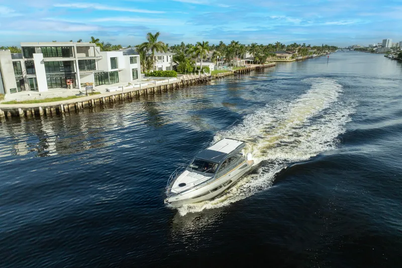 Slide: The Image of Luxury Valiatt 410HT yacht cruising along a scenic waterfront, 2025 model. - 0