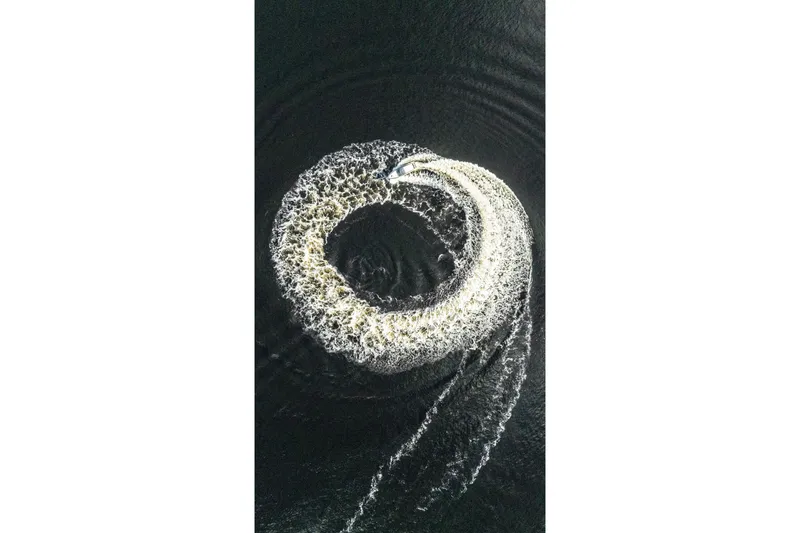 Slide: The Image of Aerial view of Valiatt 410HT boat creating circular wake pattern on water, 2025 model. - 22