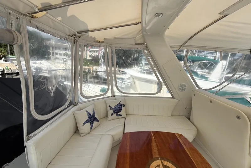 Slide: The Image of Luxurious 2004 Navigator 4800 yacht interior with plush seating and nautical-themed cushions. - 10