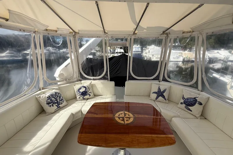 Slide: The Image of Luxurious 2004 Navigator 4800 yacht interior with nautical-themed cushions and polished wooden table. - 11