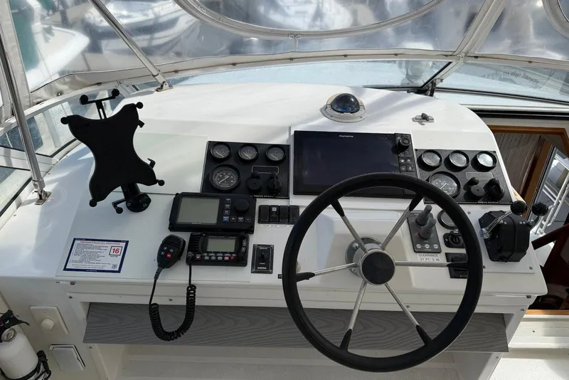 Slide: The Image of Cockpit of 2004 Navigator 4800 yacht with steering wheel and navigation instruments. - 17