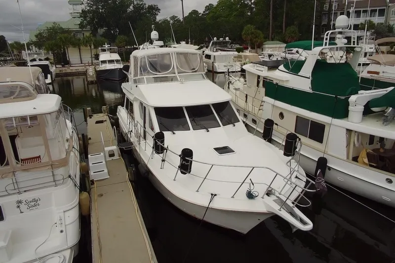 Slide: The Image of 2004 Navigator 4800 yacht docked among other boats in a marina. - 3