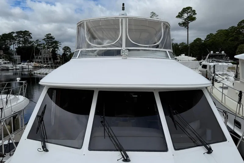 Slide: The Image of Front view of a 2004 Navigator 4800 yacht docked at a marina. - 31