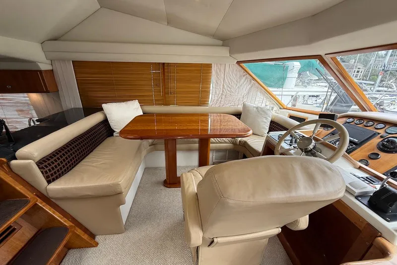 Slide: The Image of Luxurious interior of a 2004 Navigator 4800 yacht with plush seating and wooden accents. - 33