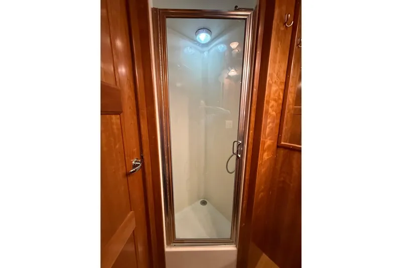 Slide: The Image of Compact shower in 2004 Navigator 4800 yacht with wooden interior. - 35