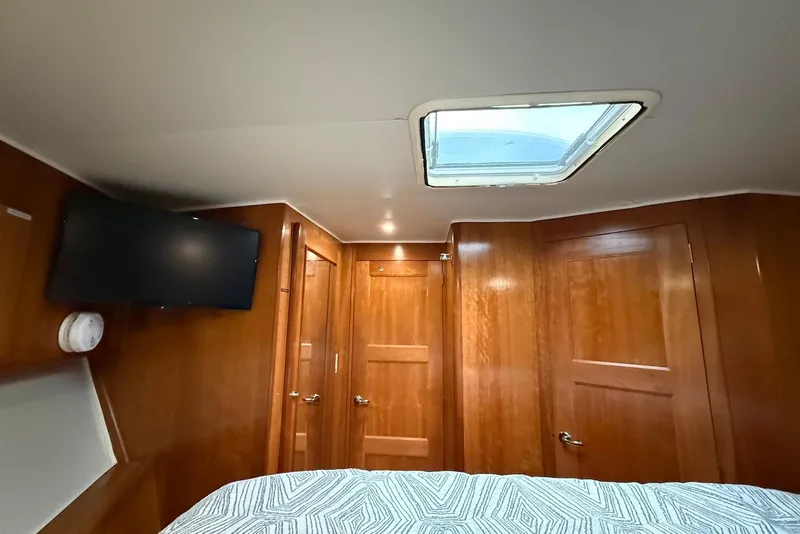 Slide: The Image of Interior of 2004 Navigator 4800 yacht cabin with wood paneling and ceiling hatch. - 39