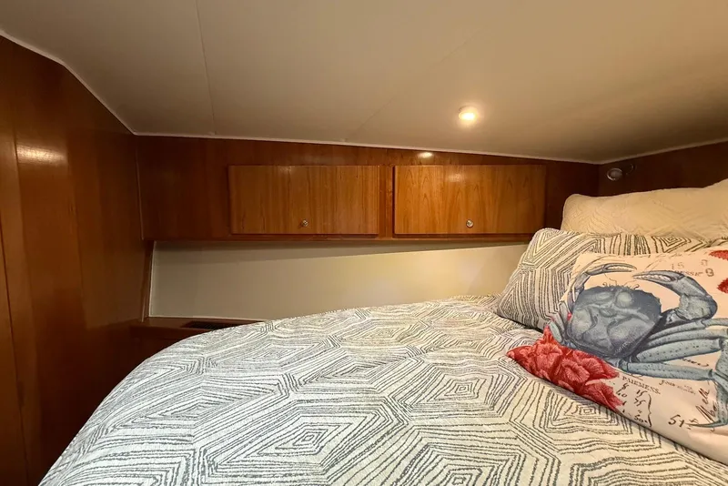 Slide: The Image of Cozy bedroom in 2004 Navigator 4800 yacht with geometric bedding and crab-themed pillow. - 40