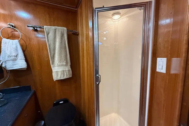 Slide: The Image of Luxurious 2004 Navigator 4800 yacht bathroom with shower, wooden paneling, and elegant towels. - 42