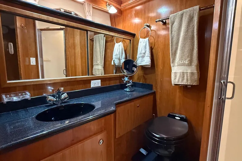 Slide: The Image of Luxurious 2004 Navigator 4800 yacht bathroom with wood paneling and modern fixtures. - 43