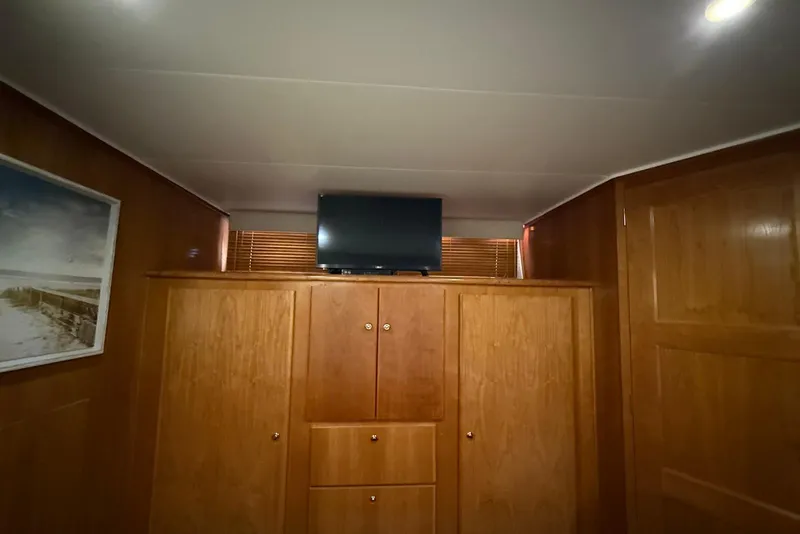 Slide: The Image of Interior of 2004 Navigator 4800 yacht with wooden cabinetry and mounted TV. - 45