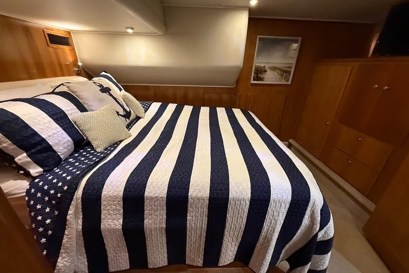 Slide: The Image of Cozy bedroom in 2004 Navigator 4800 yacht with nautical-themed bedding. - 46
