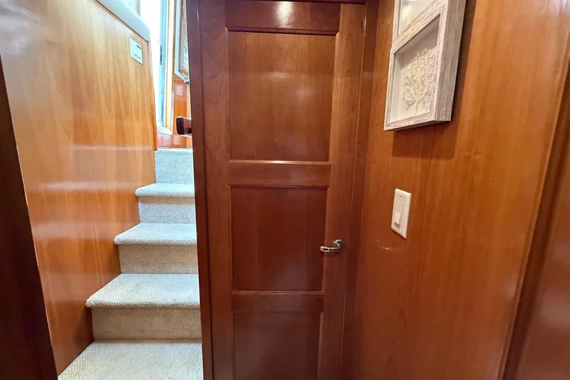 Slide: The Image of Interior of 2004 Navigator 4800 yacht with wooden door and carpeted stairs. - 49
