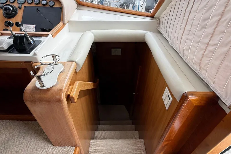 Slide: The Image of Interior of 2004 Navigator 4800 yacht showing helm and staircase to lower deck. - 51
