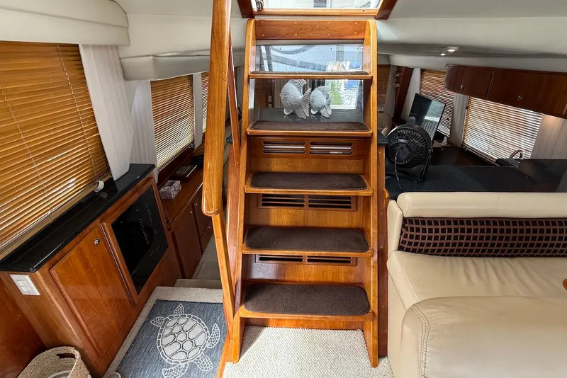 Slide: The Image of Interior of 2004 Navigator 4800 yacht with wooden stairs and elegant furnishings. - 52