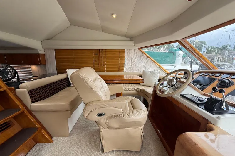 Slide: The Image of Interior of 2004 Navigator 4800 yacht with leather seating and wooden helm. - 54