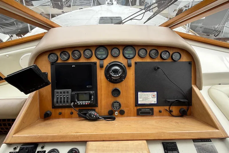 Slide: The Image of 2004 Navigator 4800 yacht dashboard with gauges, controls, and navigation equipment. - 55