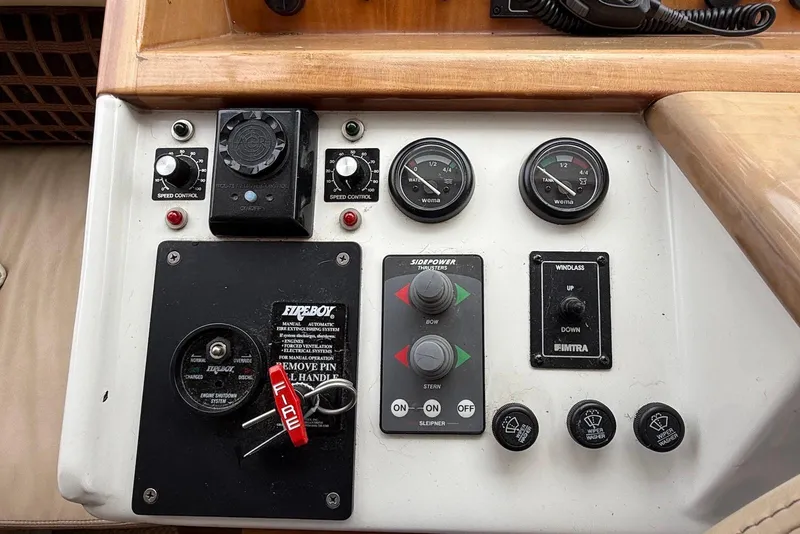 Slide: The Image of Control panel of a 2004 Navigator 4800 boat with gauges and switches. - 57