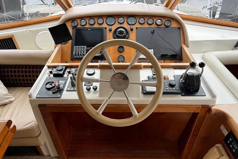 Slide: The Image of Helm of 2004 Navigator 4800 yacht with steering wheel and control panel. - 58