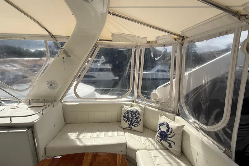 Slide: The Image of Luxurious 2004 Navigator 4800 yacht interior with white seating and nautical-themed pillows. - 6