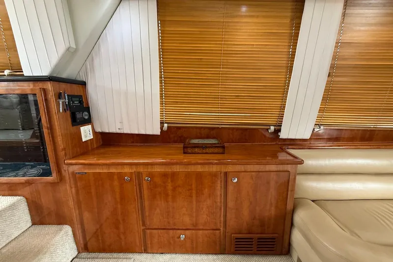 Slide: The Image of Interior of 2004 Navigator 4800 yacht with wooden cabinetry and beige seating. - 61