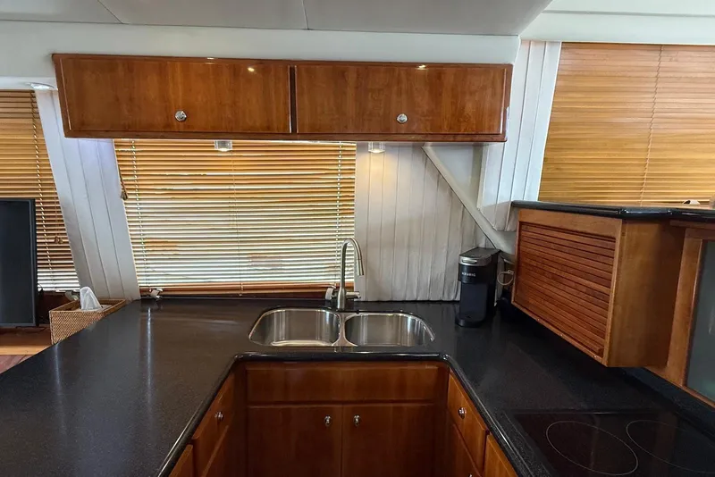 Slide: The Image of Luxurious kitchen interior of 2004 Navigator 4800 yacht with wooden cabinets and modern appliances. - 63