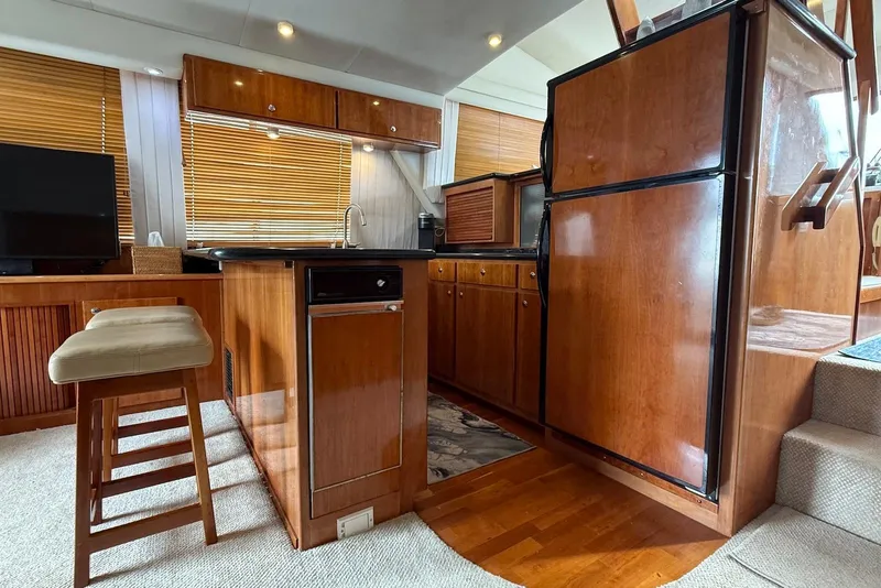 Slide: The Image of Luxurious 2004 Navigator 4800 yacht interior with wooden cabinetry and modern amenities. - 65