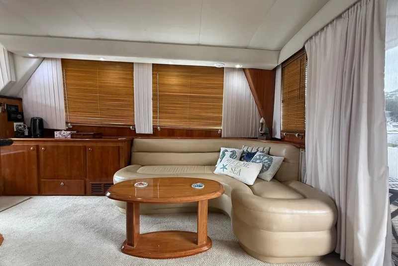 Slide: The Image of Luxurious 2004 Navigator 4800 yacht interior with leather seating, wooden blinds, and nautical decor. - 67