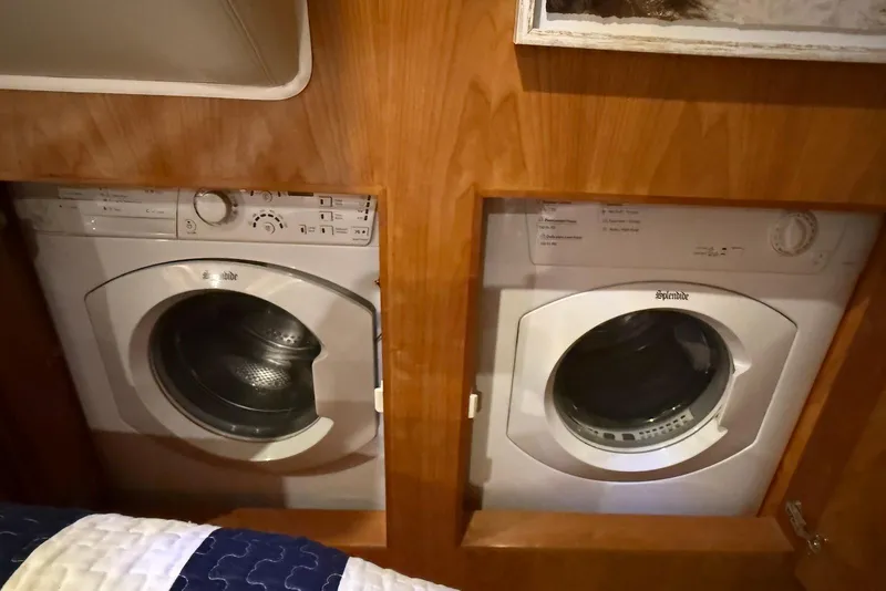 Slide: The Image of Built-in washer and dryer in 2004 Navigator 4800 yacht, wooden cabinetry. - 69