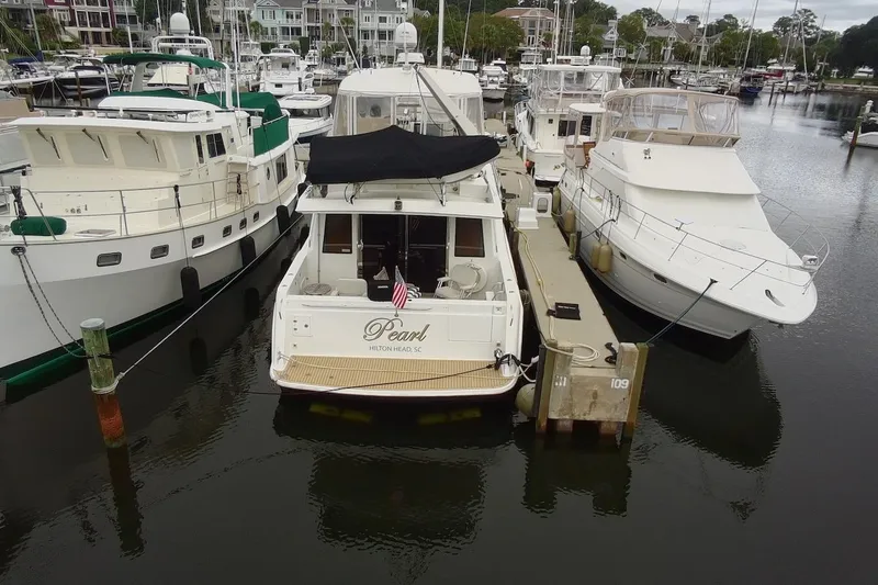 Slide: The Image of Docked 2004 Navigator 4800 yacht named "Pearl" in a marina setting. - 7