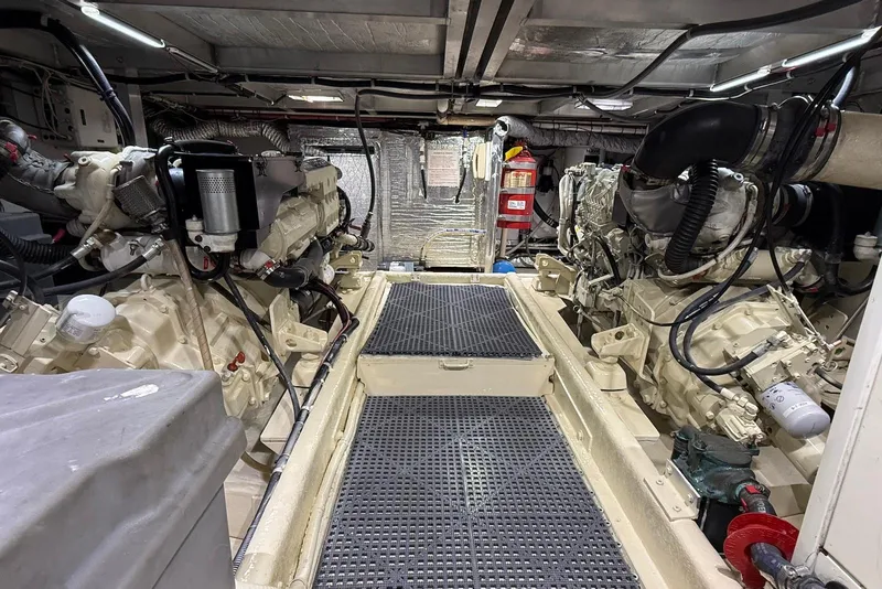 Slide: The Image of Engine room of 2004 Navigator 4800 yacht, featuring dual engines and fire safety equipment. - 70