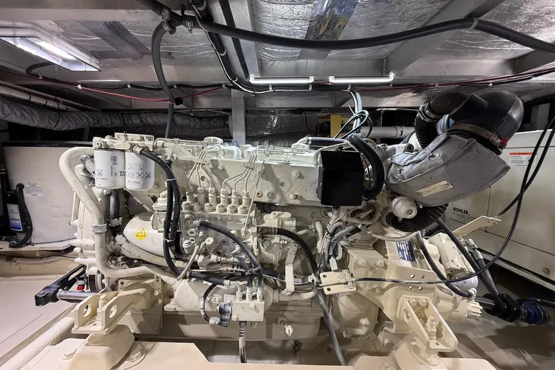 Slide: The Image of Engine room of a 2004 Navigator 4800 yacht, showcasing detailed machinery and components. - 73