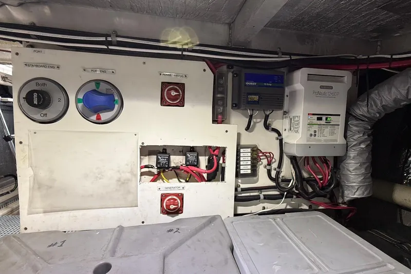 Slide: The Image of Electrical panel of a 2004 Navigator 4800 boat, featuring switches and wiring. - 74