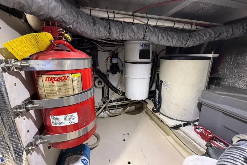 Slide: The Image of Engine room of 2004 Navigator 4800 with fire extinguisher and equipment. - 79