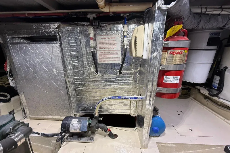 Slide: The Image of Engine room of a 2004 Navigator 4800 yacht with fire extinguisher and equipment. - 80