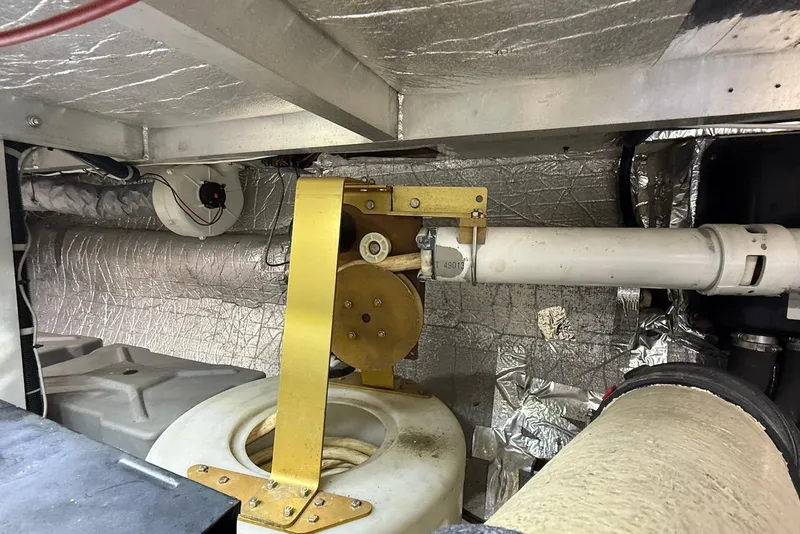 Slide: The Image of Engine room of 2004 Navigator 4800 yacht with mechanical components and insulation. - 81