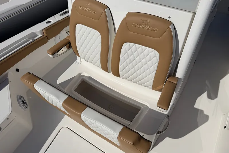 Slide: The Image of 2025 Regulator 26XO boat seat with tan and white quilted upholstery. - 22
