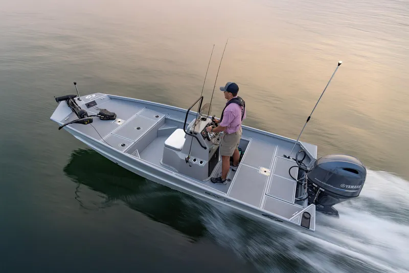 Slide: The Image of Man steering 2026 G3 Bay 17 boat on calm water, equipped with Yamaha motor. - 14