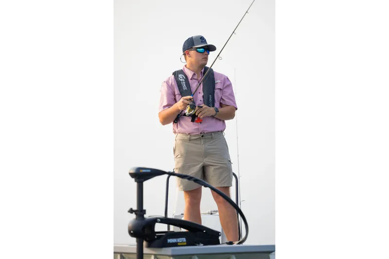 Slide: The Image of Man fishing on a G3 Bay 17 boat, wearing sunglasses and a life vest, 2026 model. - 22