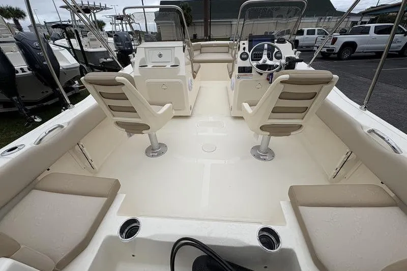Slide: The Image of 2026 Scout 195 Sport Dorado boat interior with beige seating and steering wheel. - 11