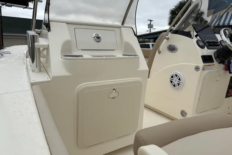 Slide: The Image of 2026 Scout 195 Sport Dorado boat interior with seating and steering console. - 12