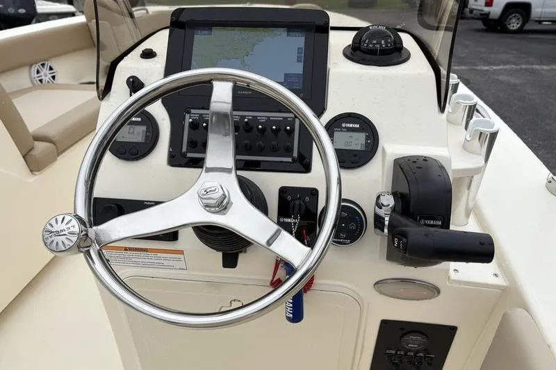 Slide: The Image of 2026 Scout 195 Sport Dorado boat interior with helm and storage compartments. - 13