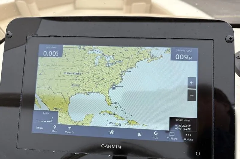 Slide: The Image of 2026 Scout 195 Sport Dorado boat dashboard with steering wheel and navigation controls. - 14