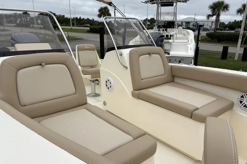 Slide: The Image of 2026 Scout 195 Sport Dorado boat interior with beige seating and console. - 17