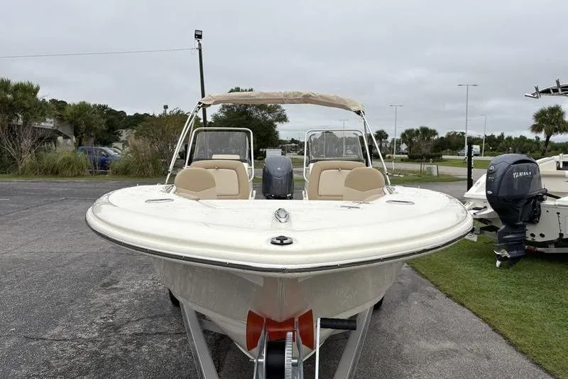 Slide: The Image of 2026 Scout 195 Sport Dorado boat on trailer, parked outdoors. - 7