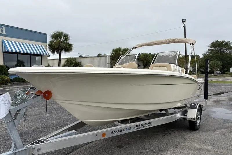Slide: The Image of 2026 Scout 195 Sport Dorado boat on trailer, parked outdoors. - 8